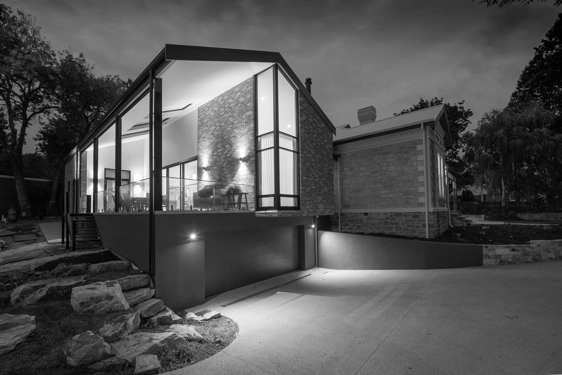 a black and white photo of a house at night